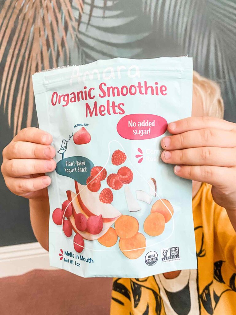 vegan kid holding up bag of amaras organic smoothie melts