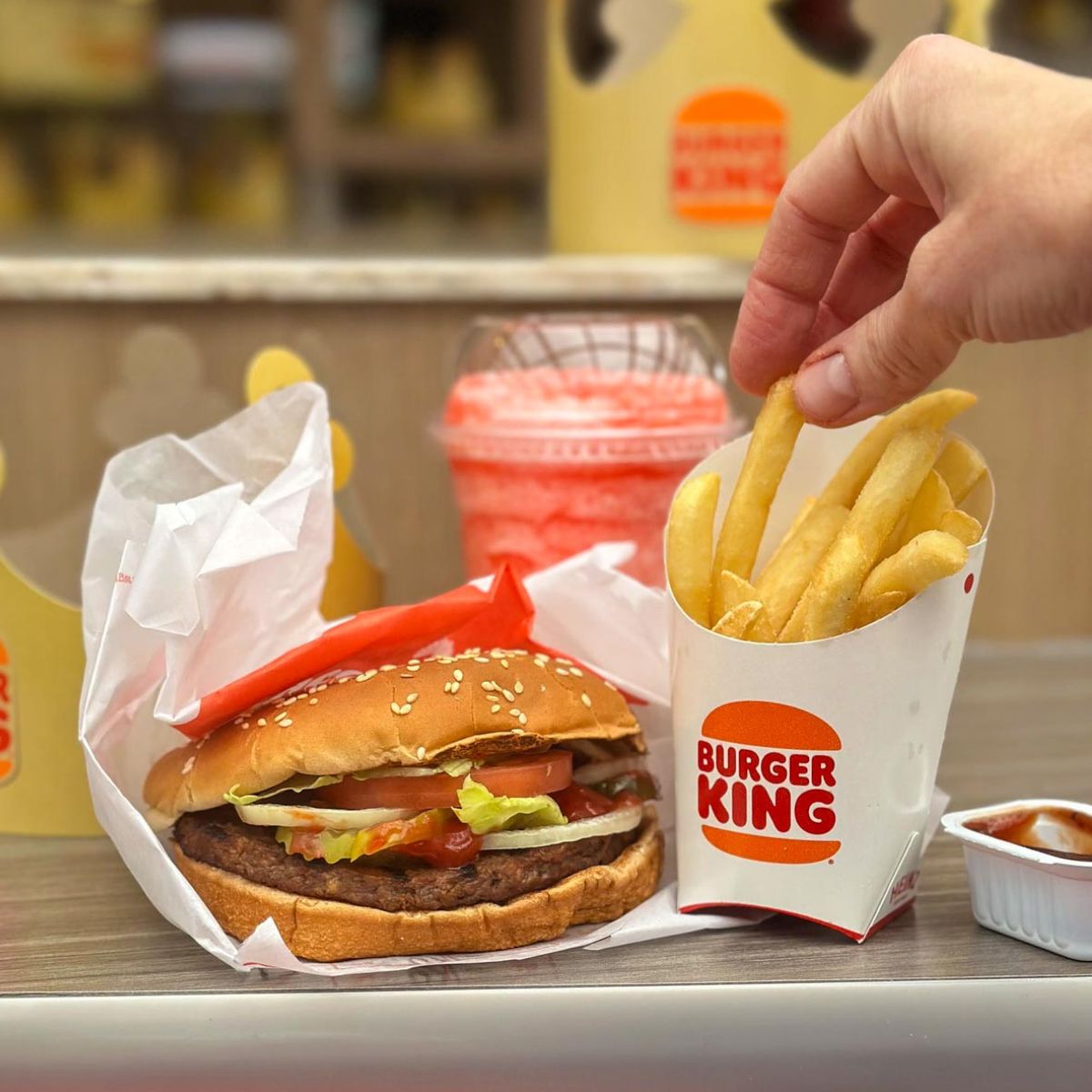 A collection of vegan items at Burger King including the Impossible Whopper, fries, and slushie.