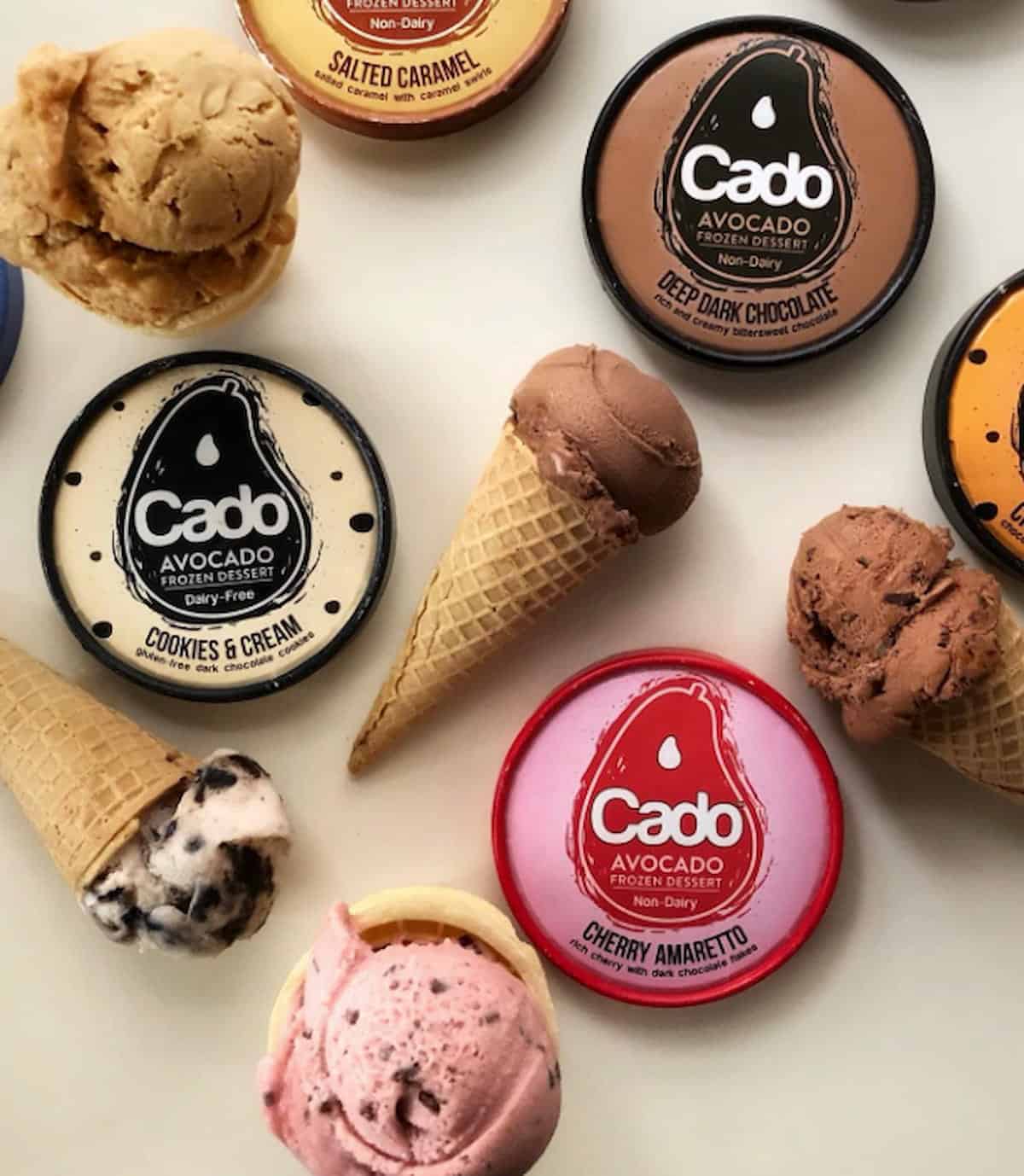 Containers of Cado frozen dessert next to waffle cones.