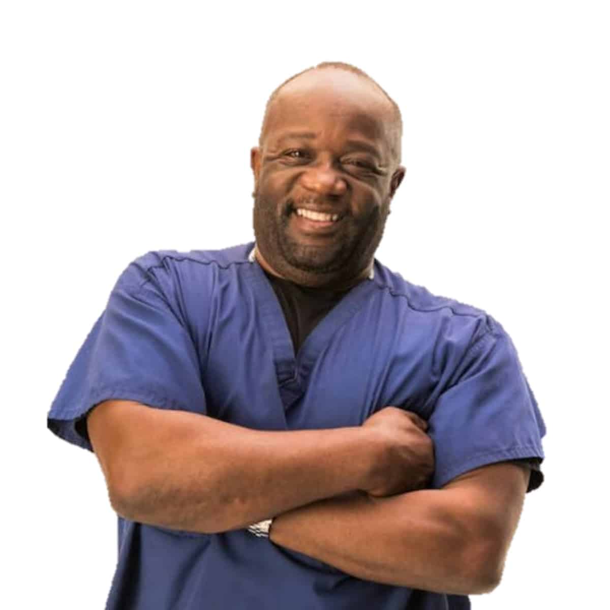 Photo of plant-based doctor Milton Mills wearing a blue scrub outfit. 