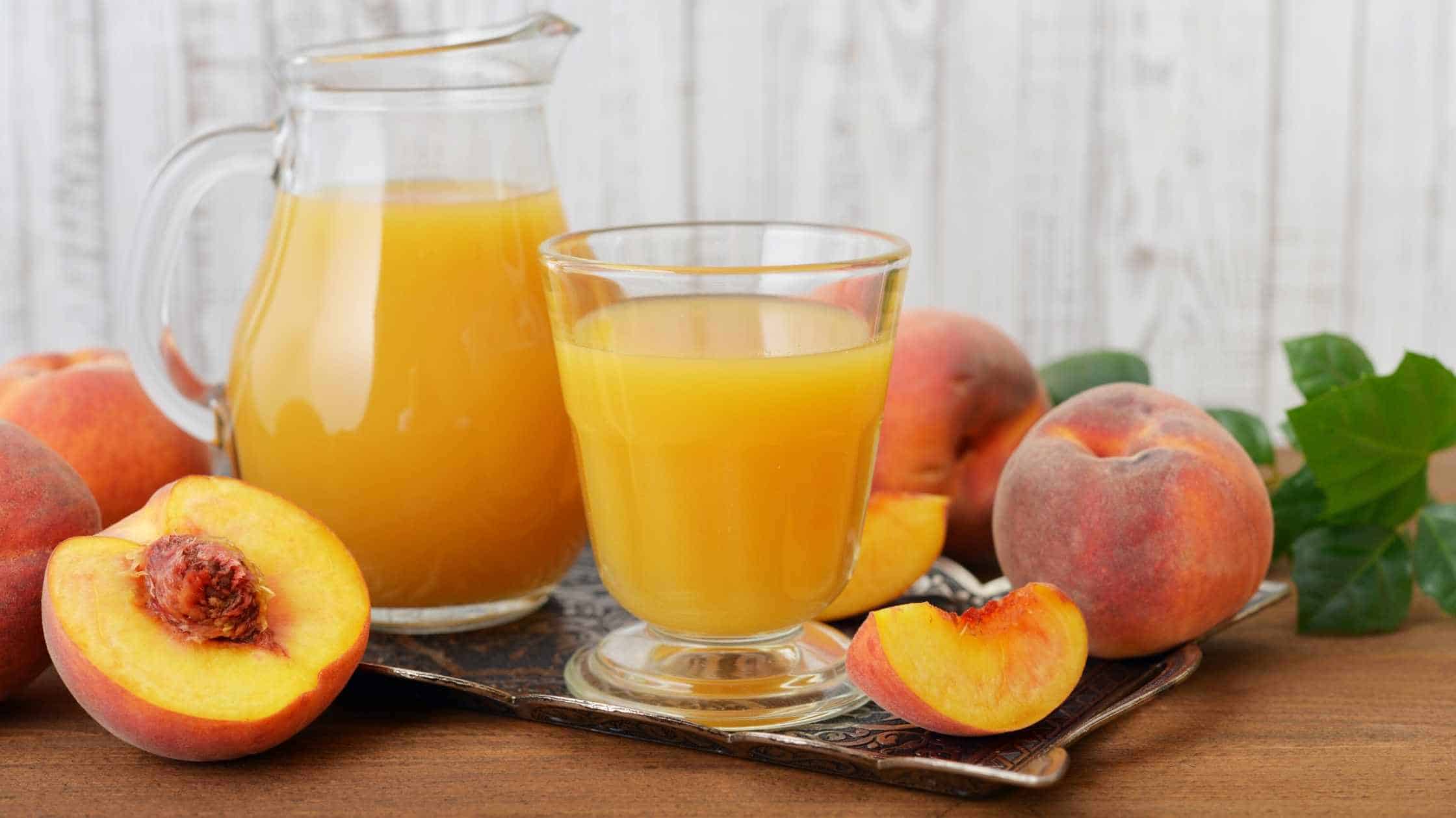 easy homemade peach juice surrounded by fresh peaches