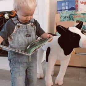 vegan toddler with big cow stuffed animal