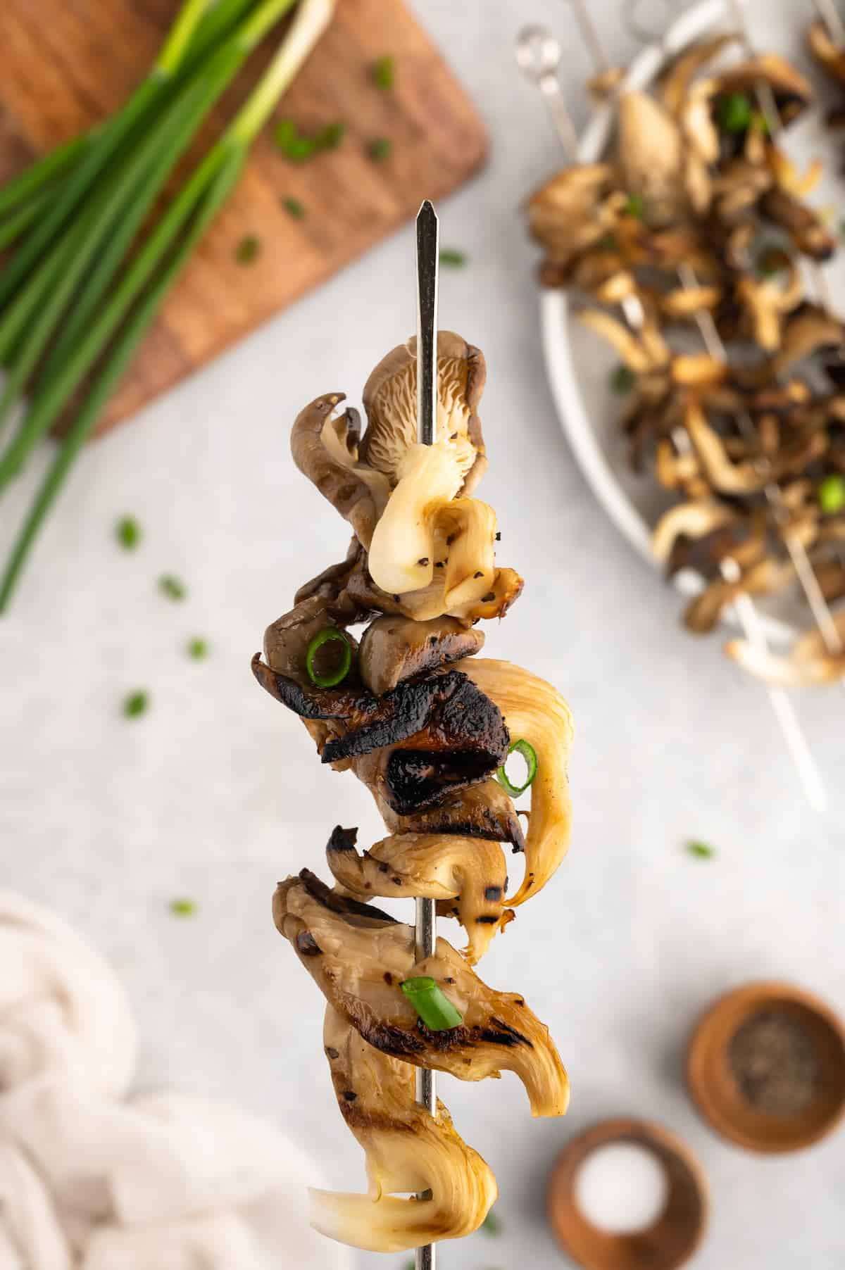 A close-up shot of grilled mushroom skewers.