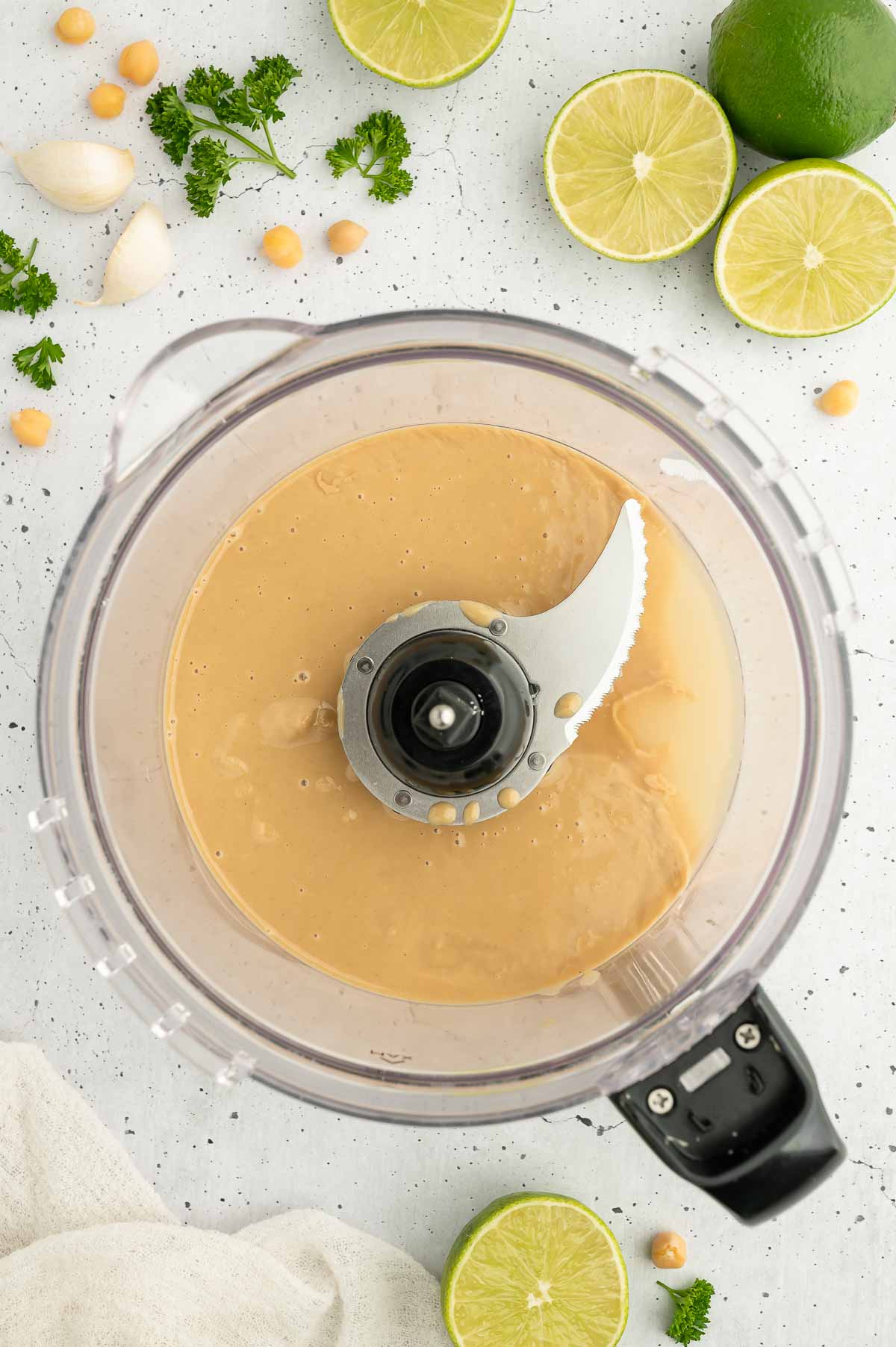 Tahini and lime juice in a food processor.