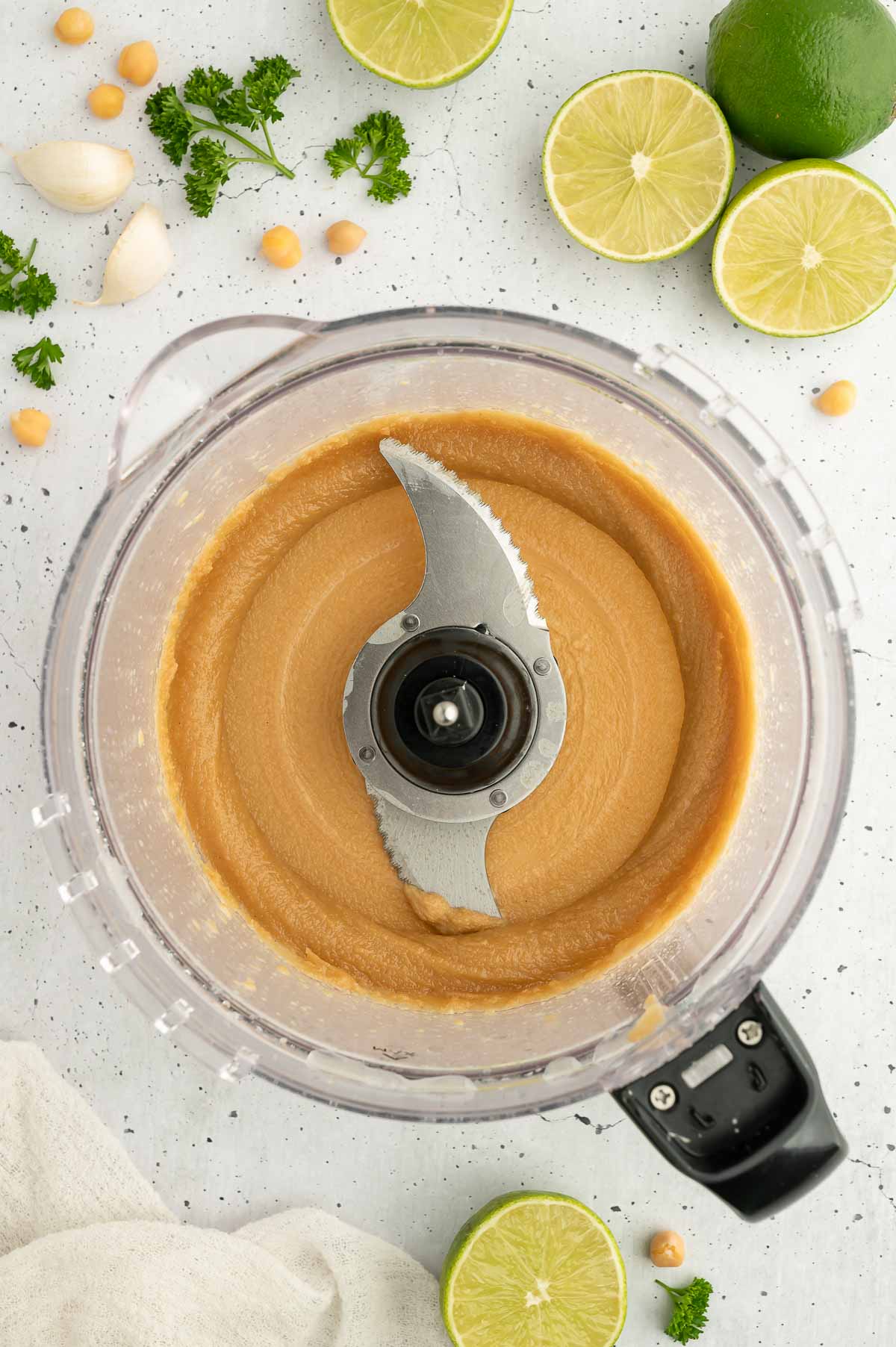 Hummus being prepped in a food processor.