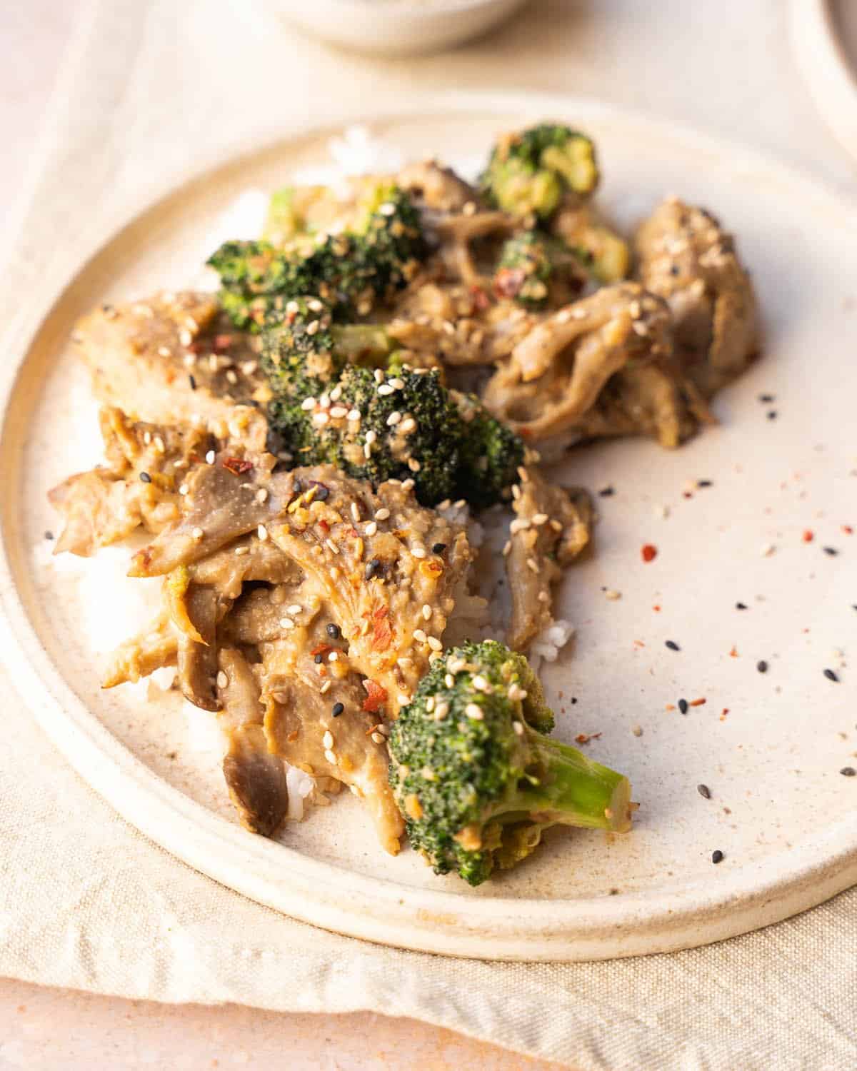 A plate of stir fried oyster mushrooms and broccoli.