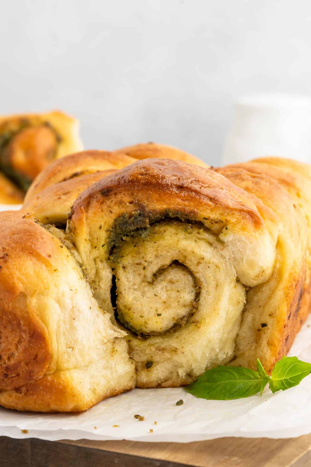 A piece of pesto bread, shot from the side to show the interior swirl pattern.