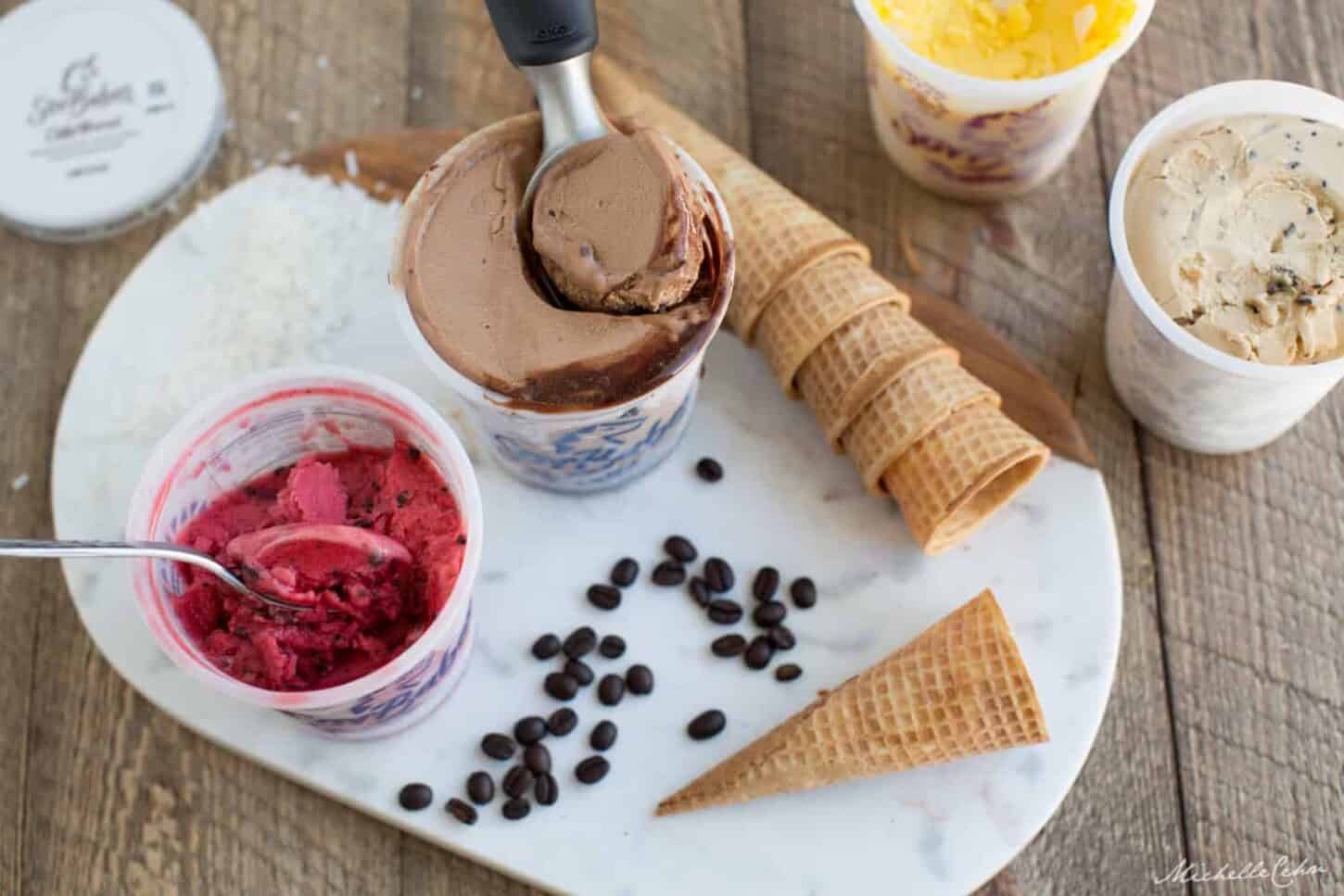 Pints of dairy-free ice cream with waffle cones.