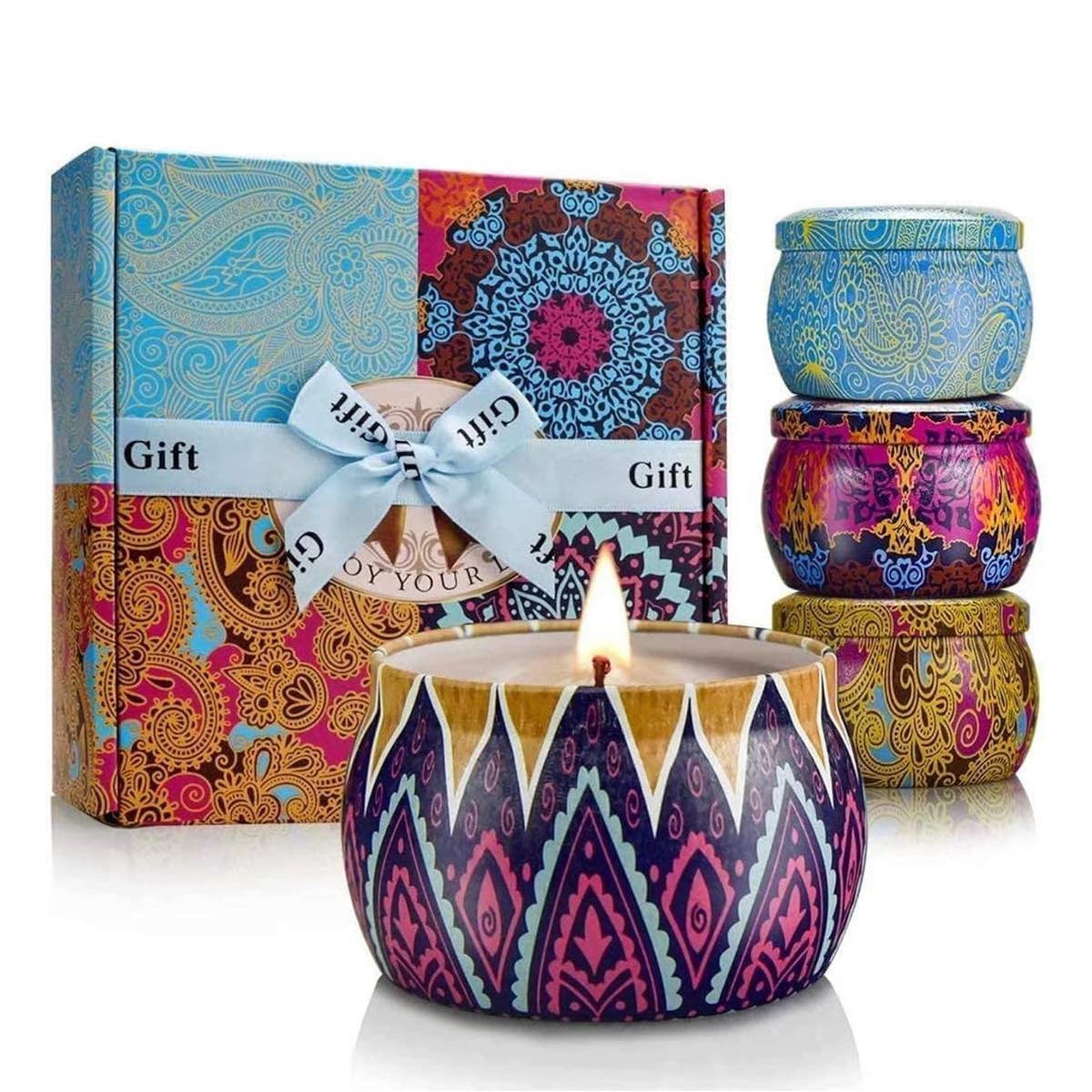 Four beautifully designed soy candles in metal tins packaged in a decorative gift box.