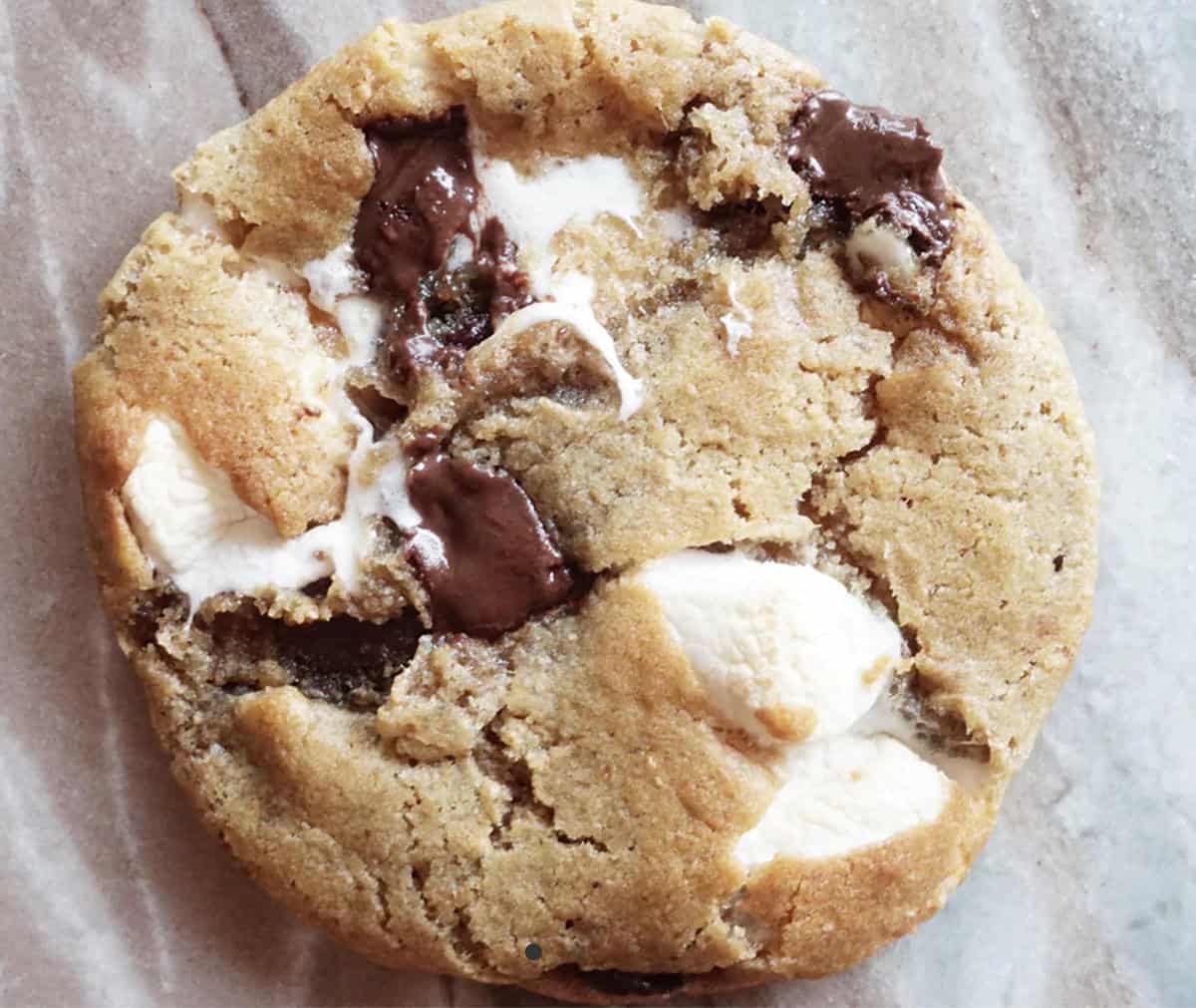 S'mores vegan cookie with marshmallows and chocolate chips in it.
