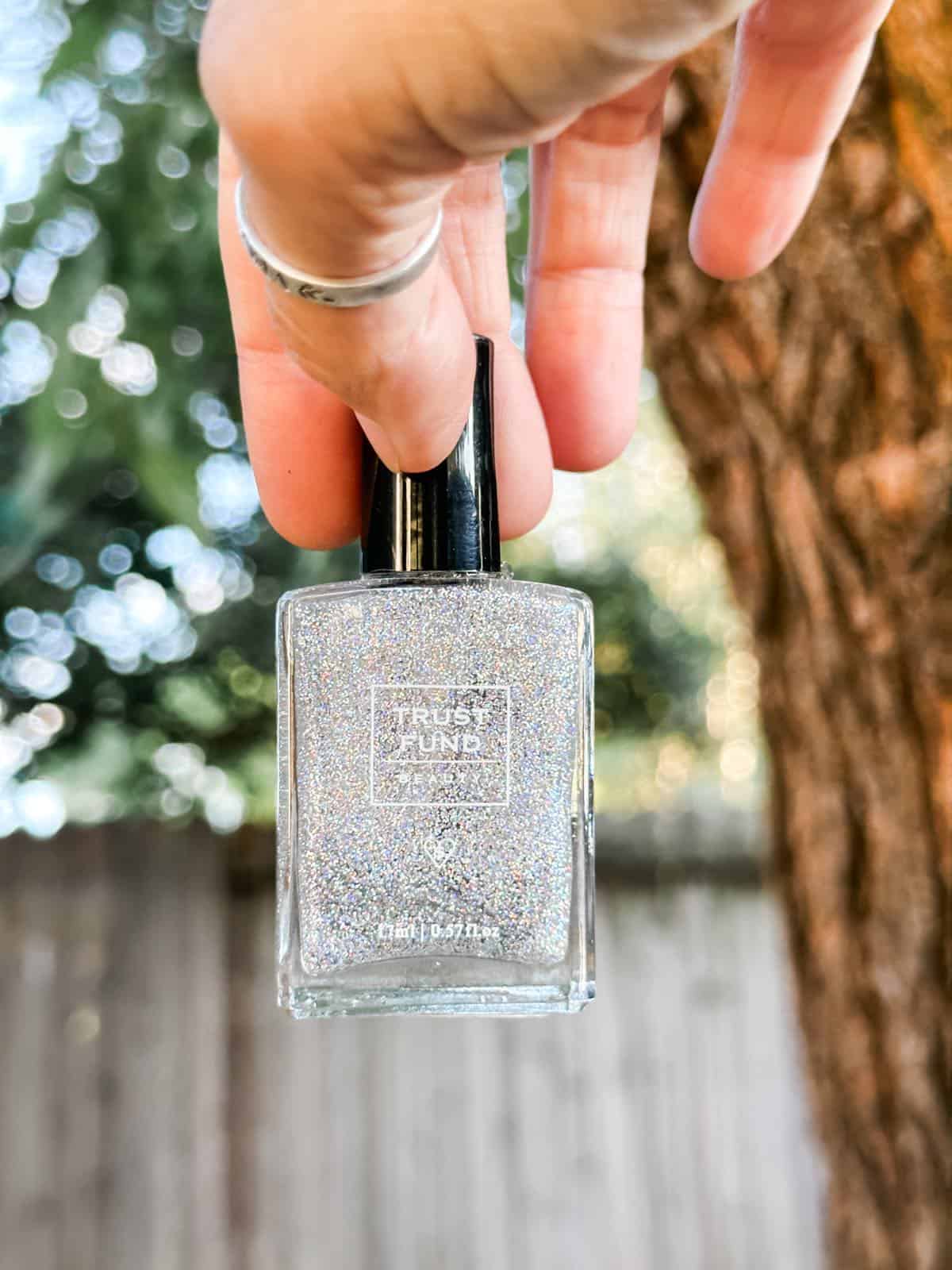 Silver sparkly nail polish from Trust Fund Beauty in cruelty-free vegan bottle.