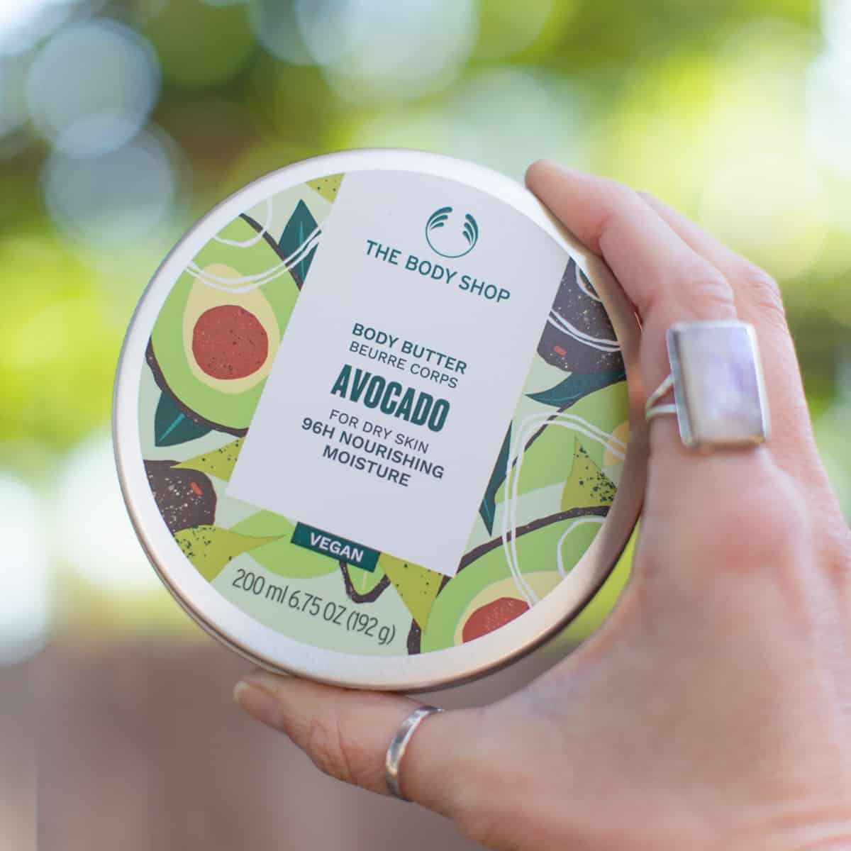 A tin of Avocado body butter for dry skin from The Body Shop brand of vegan lotion.