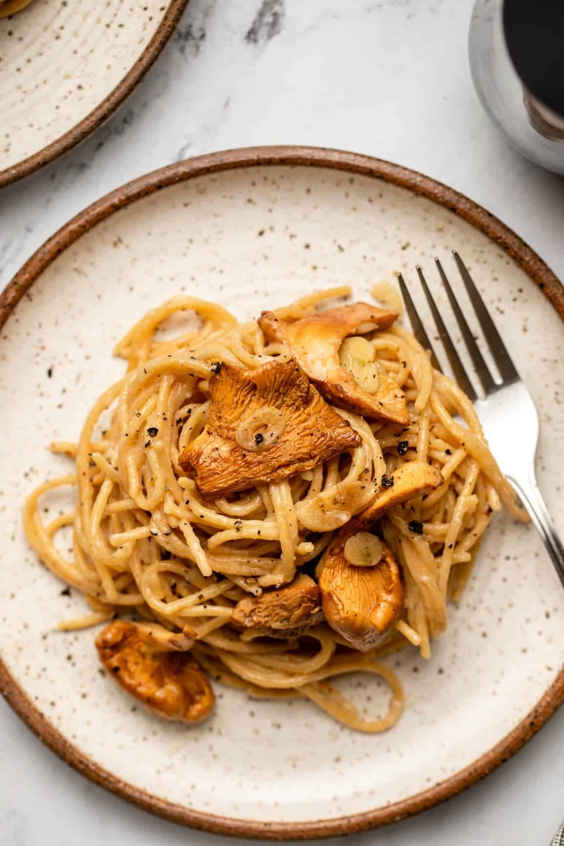 vegan cacio e pepe on a plate with oyster mushrooms.