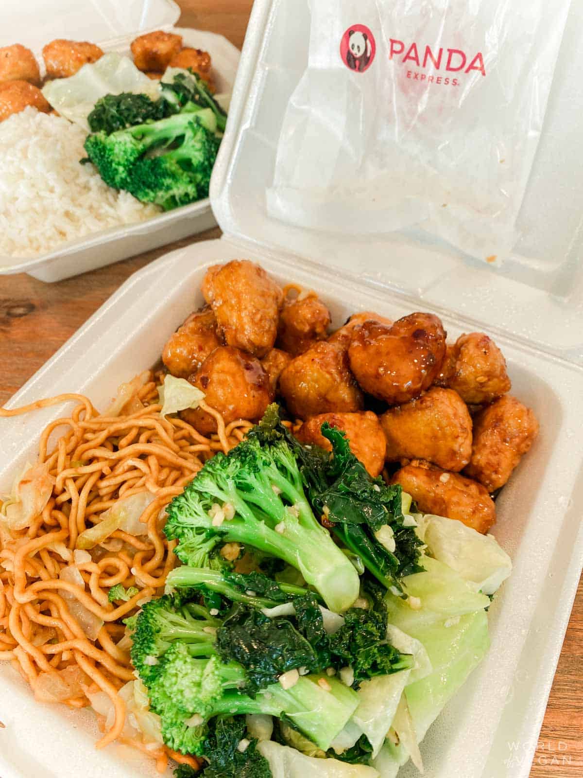takeout box of vegan items from panda express with beyond orange chicken chow mein and super greens