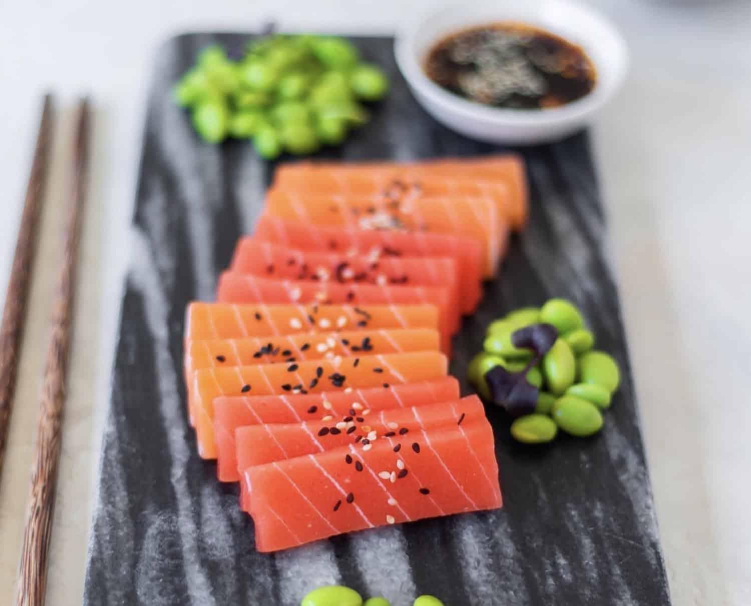 Vegan Zeastar Salmon Sashimi on a plate with edamame and sesame seeds