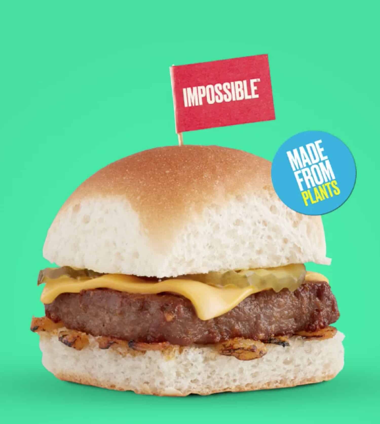 A bright green background with a close up of a plant-based Impossible slider burger with small red flag on top offered at White Castle.