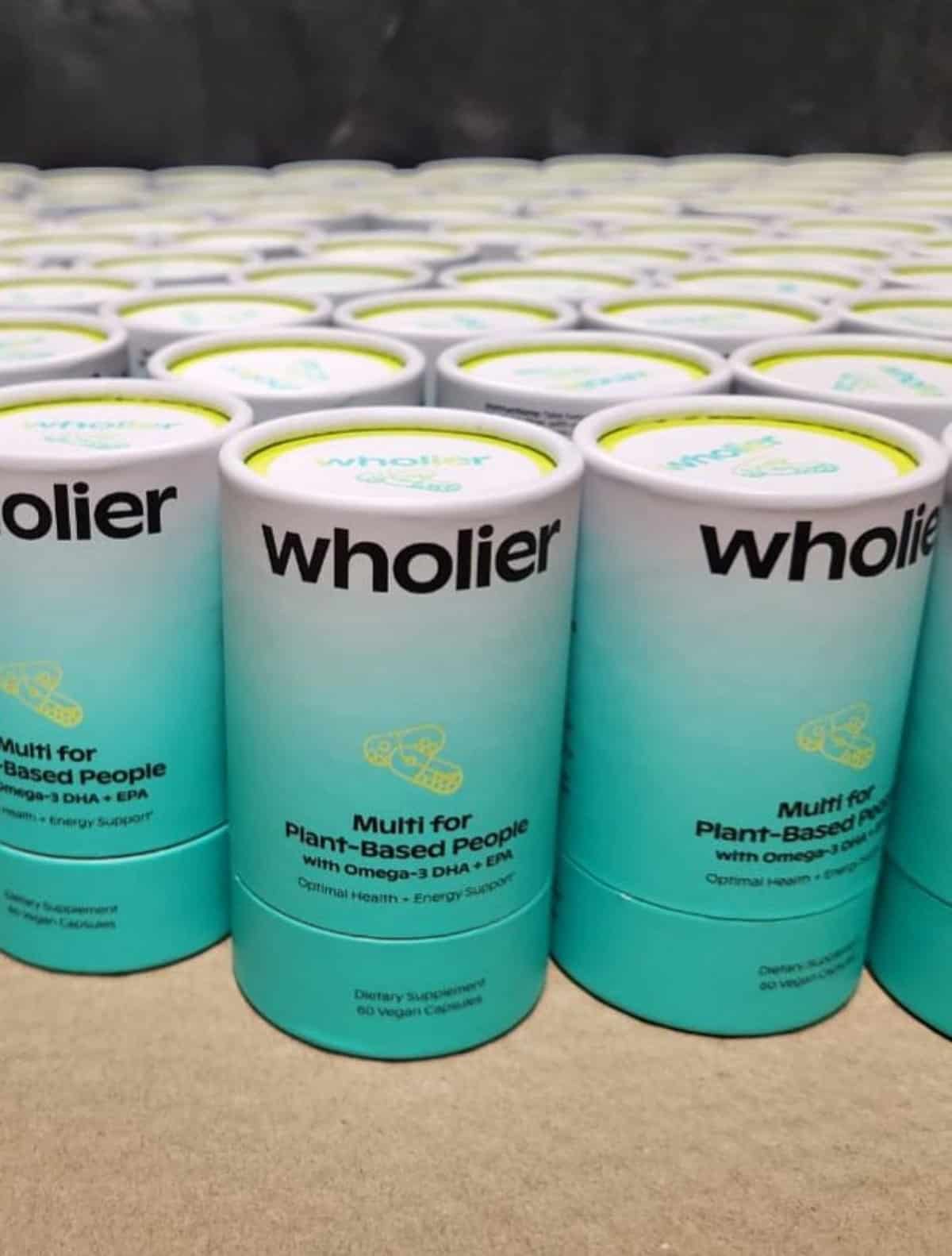 Containers of Wholier brand vegan multivitamins.
