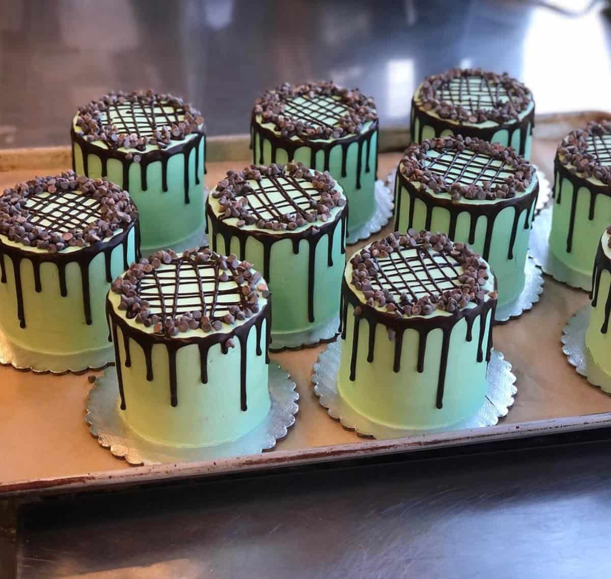 A cluster of Chocolate Creme de Menthe cakes on individual cake platters.